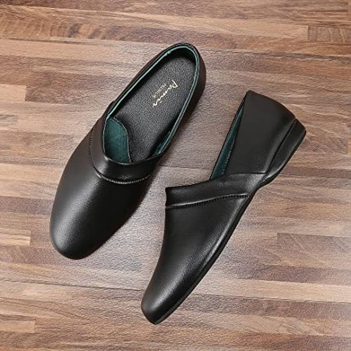 Pair of men's black leather house slippers, slip-on style with teal-lined interior
