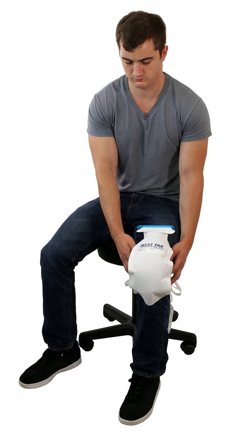 Large insulated ice bag with tie strings and blue top tab, fastened on leg