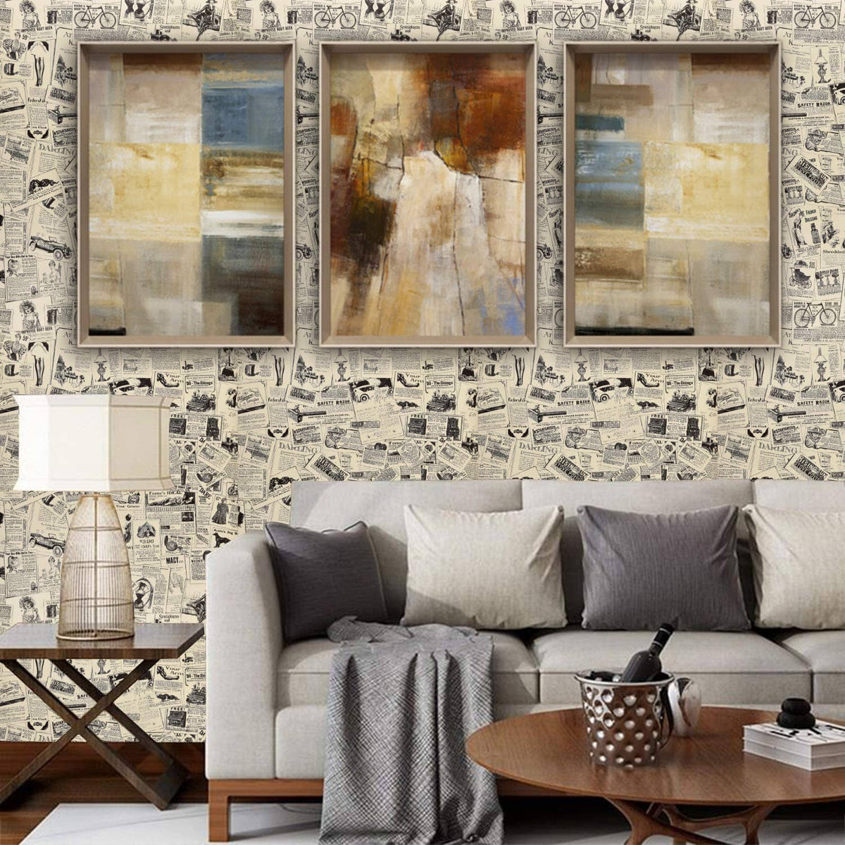 Newspaper-pattern wall covering with three framed panels above a gray sofa
