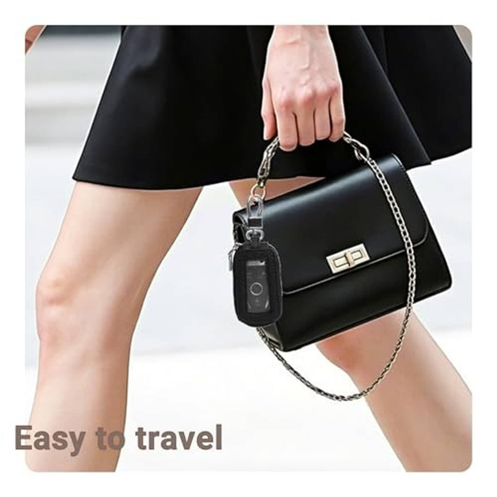 Black leather key fob case with metal chain and key ring, hanging from a hand
