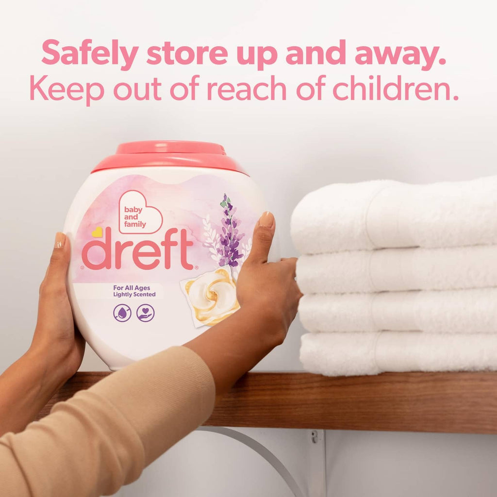Dreft light-scent lavender detergent bottle held above folded towels