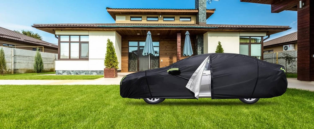 Black car cover with zipper flap fitted over a sedan in a yard