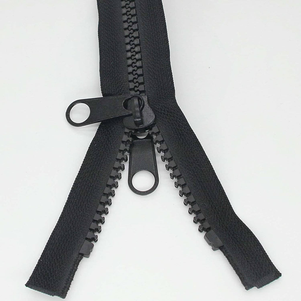 Black separating zipper with two pull tabs and looped slider, teeth fully visible