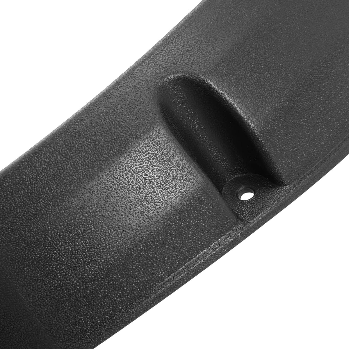 Close-up of black textured fender flare with raised mounting tab and screw hole.