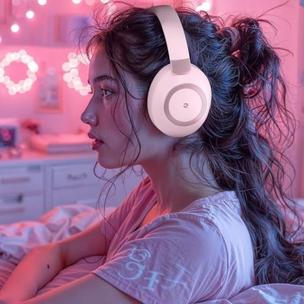Pink wireless over-ear headphones worn by a woman, side profile view