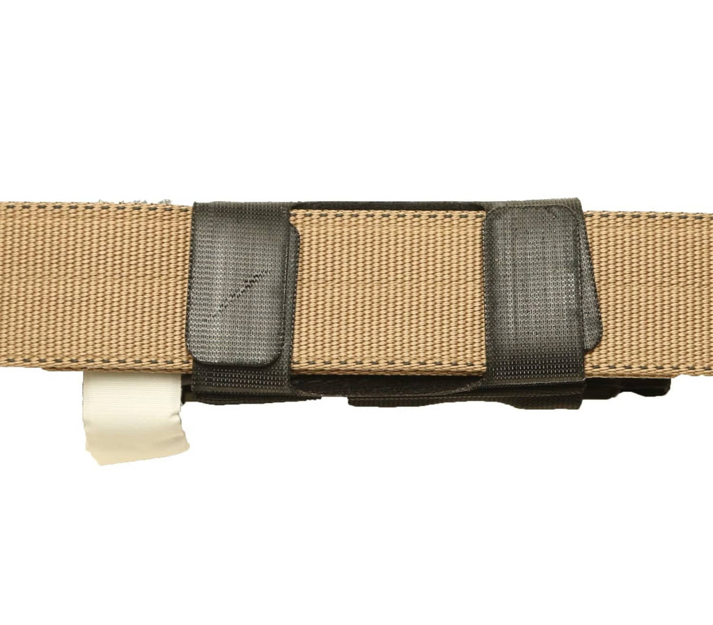 Black tourniquet holder with hook-and-loop securing panels on a belt