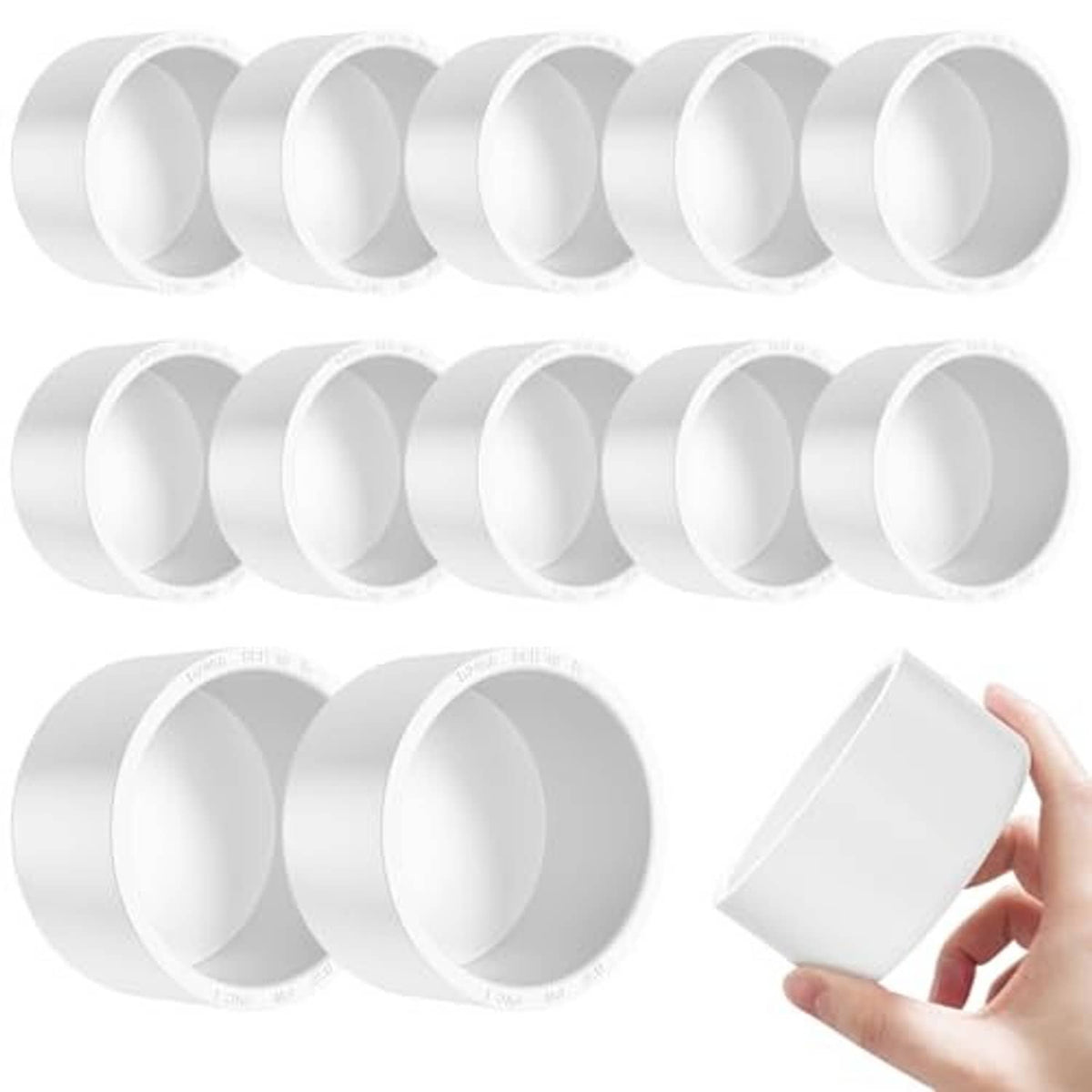 White 1-1/2 inch PVC pipe end caps, 12-pack, with one cap held up