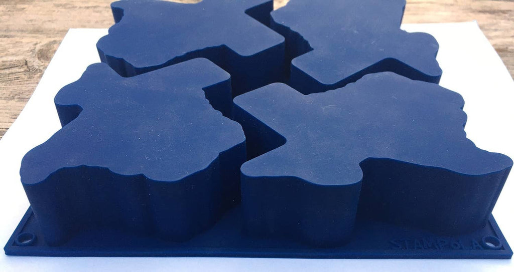 Medium blue silicone baking mold with Texas-shaped cavities, stacked view