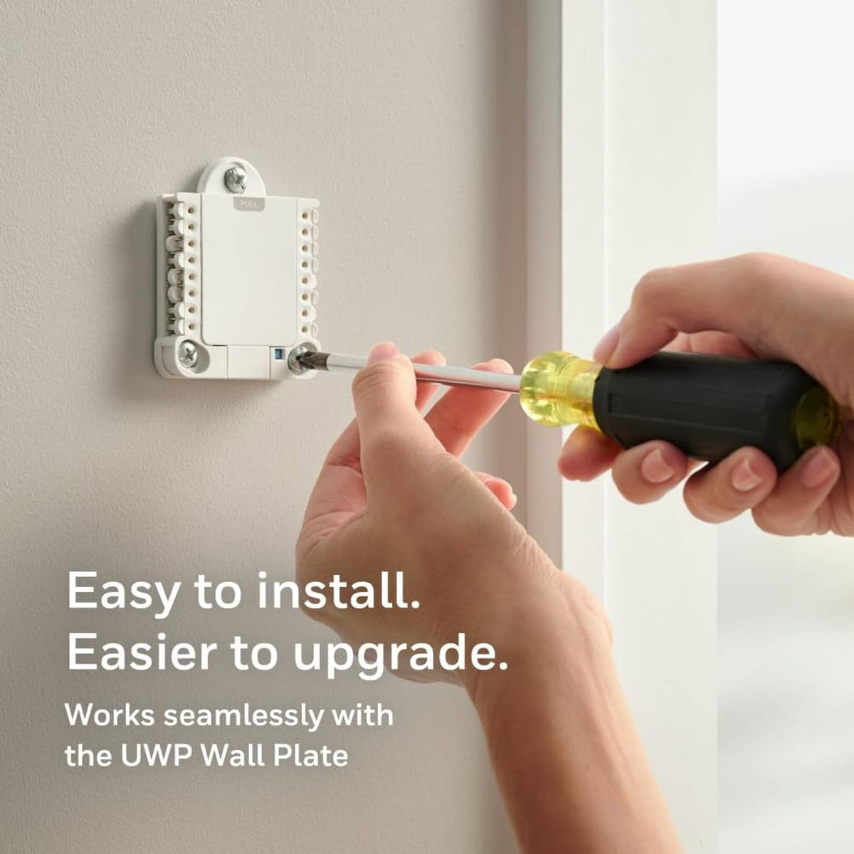 Smart thermostat installation showing wiring connected to a wall plate