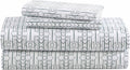 Queen sheet set in white cotton flannel with navy geometric pattern, folded stack