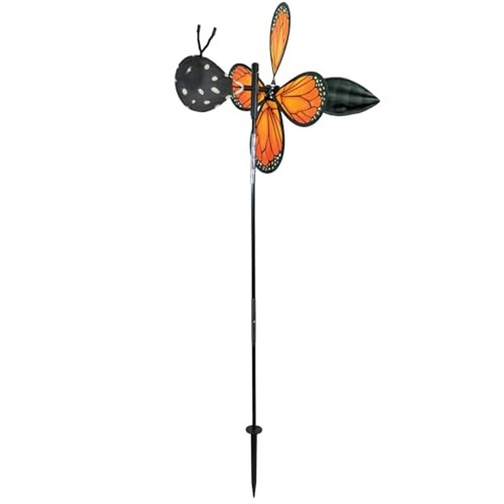 Monarch butterfly pivoting wind spinner with dark wings on a metal stake
