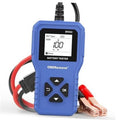 Blue handheld battery tester with LCD screen and red/black clamp leads attached