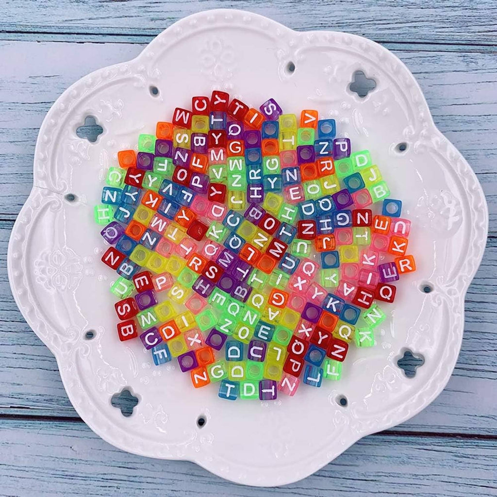 Heart-shaped tray filled with colorful alphabet and number cube beads