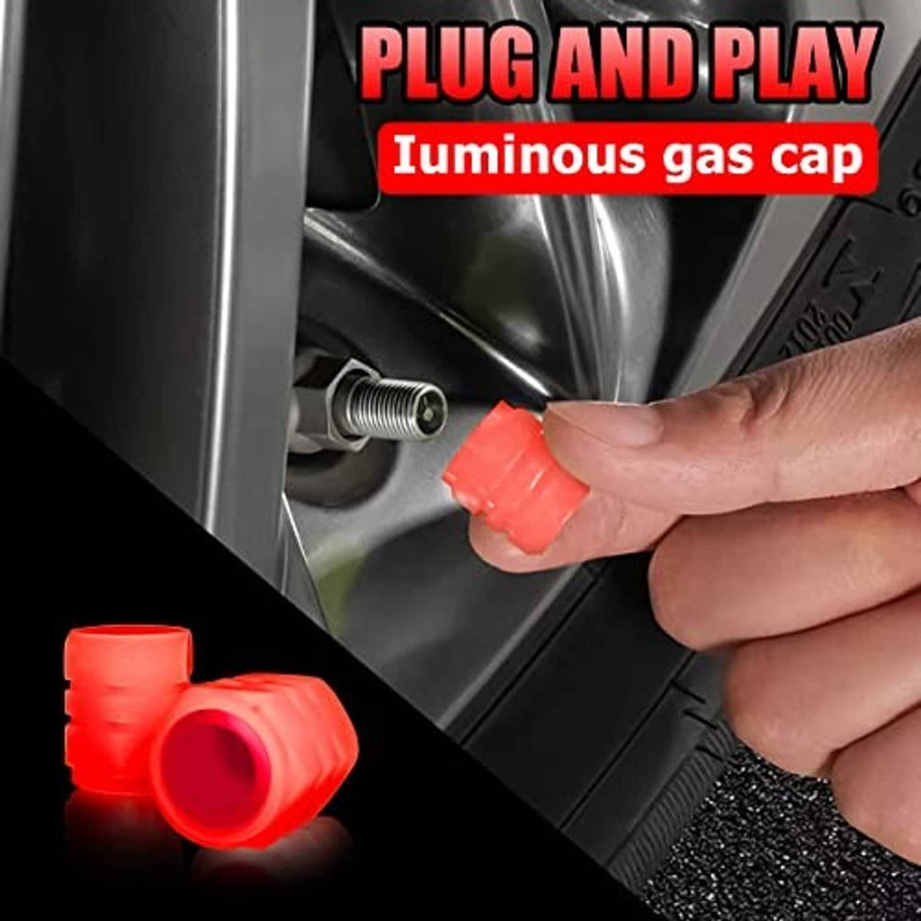 Red tire valve stem caps being installed by hand on a wheel valve, plug-and-play style