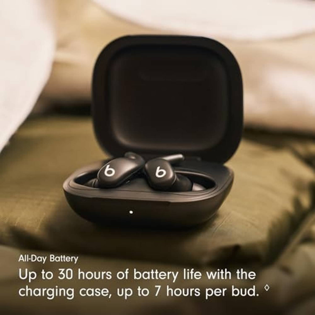 Dark wireless earbuds resting in open charging case