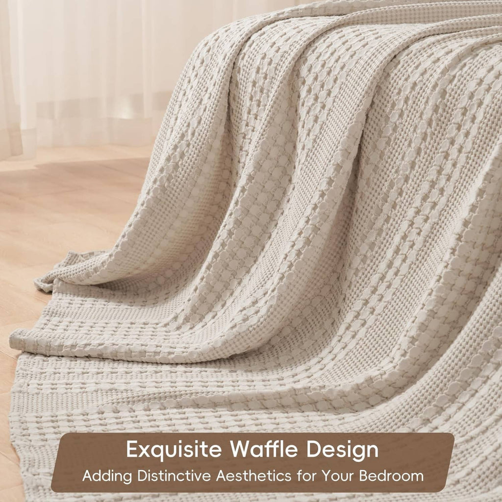 Ivory waffle-weave cotton blanket with ribbed diamond texture, loosely draped