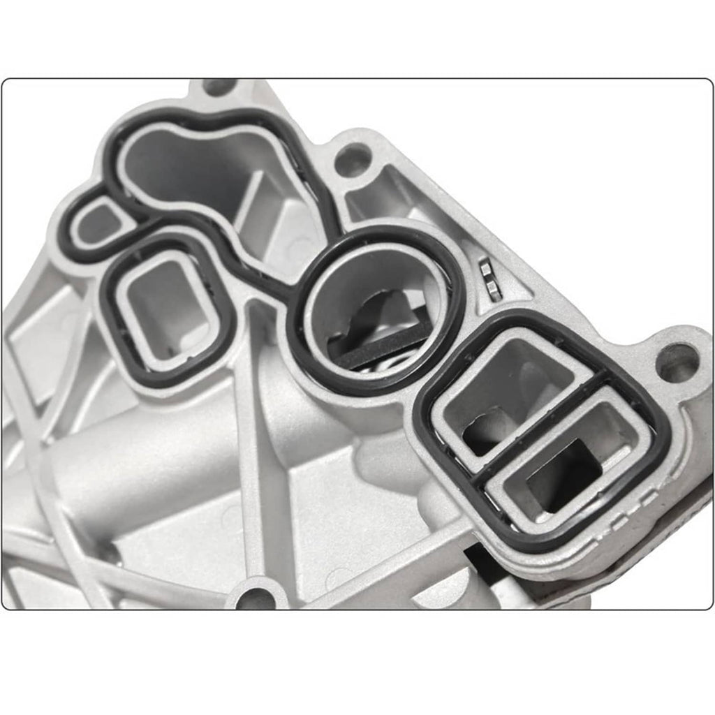 Oil cooler filter housing close-up showing ports, gasket seals, and aluminum mounting area