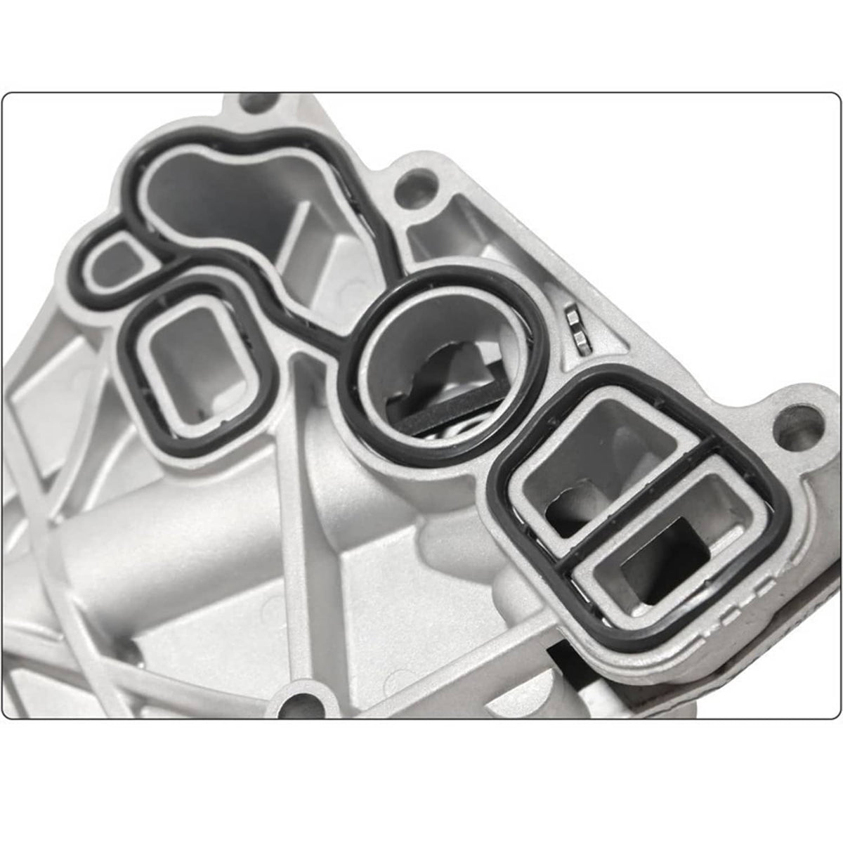 Oil cooler filter housing close-up showing ports, gasket seals, and aluminum mounting area
