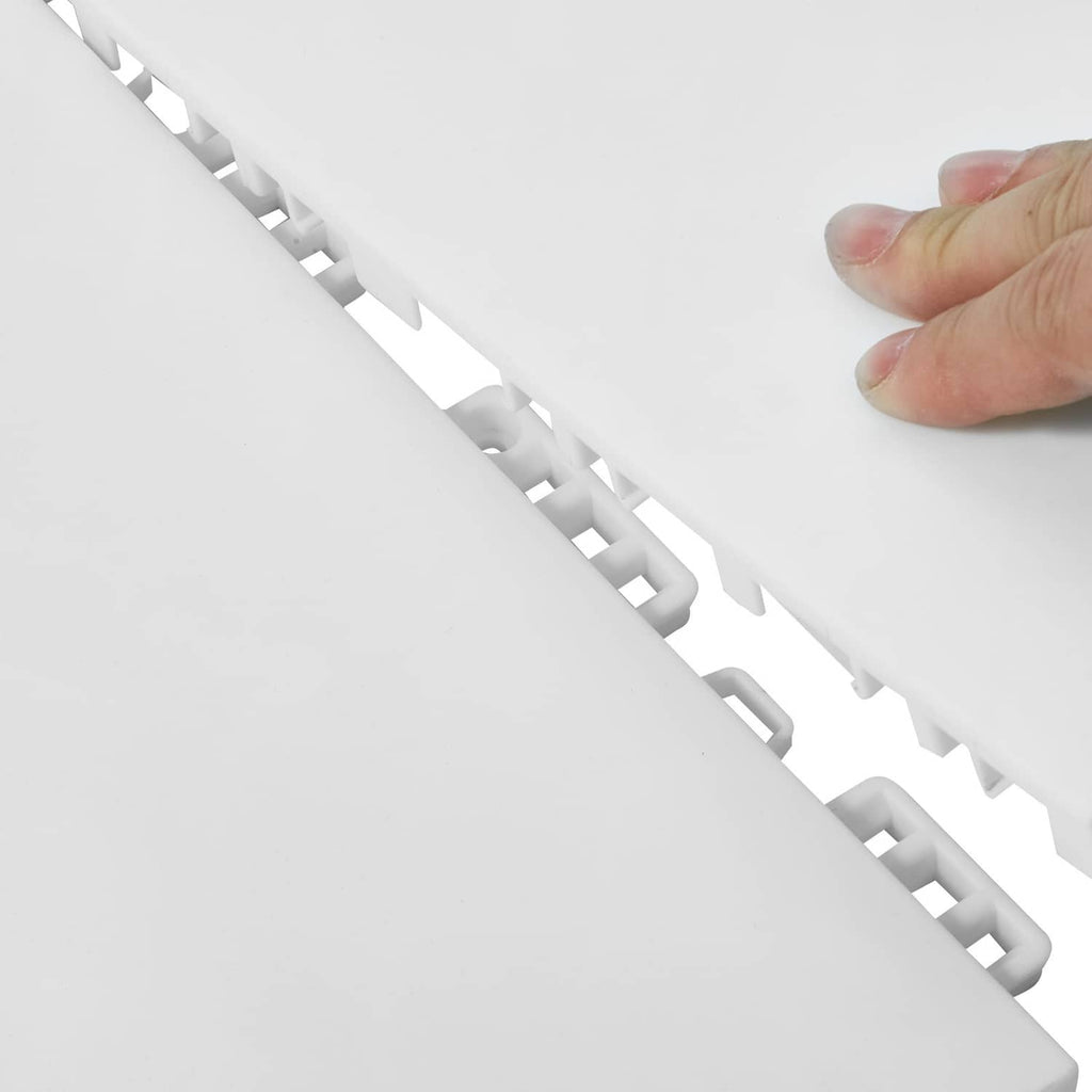 Interlocking rubber mat tiles, light color, close-up of connected edge pieces