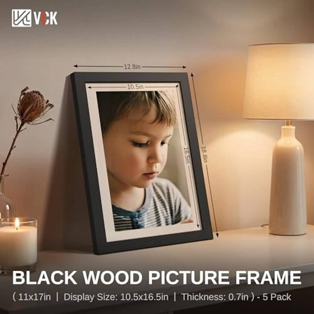 Black 11x17 picture frame with child portrait photo, angled on display