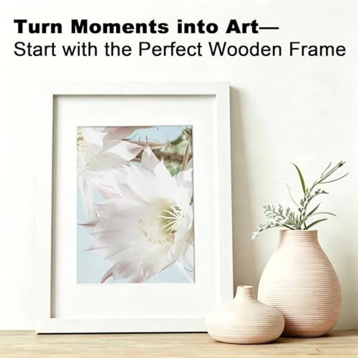 White wooden picture frame with flower artwork print, displayed indoors