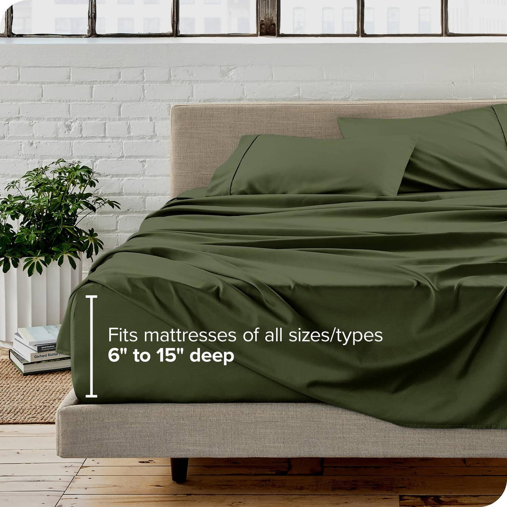 Olive green bed sheet set on a beige mattress, with pillowcases