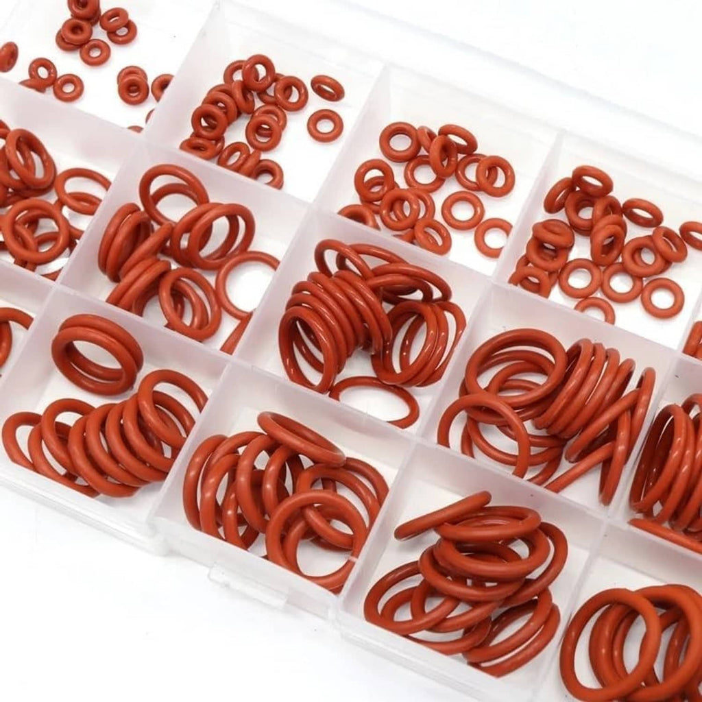 Assorted red silicone O-rings in square compartments, close-up of multiple sizes