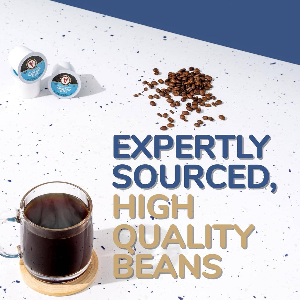 Victor Allen's coffee cup with roasted beans and pod cups on countertop