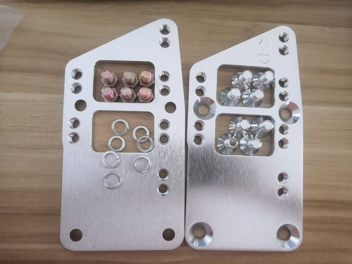 Engine motor mount adapter plates with installed hardware: hex bolts and ring washers