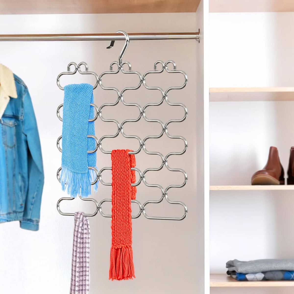 Chrome loop scarf hangers on a closet rod, holding blue, red, and patterned scarves