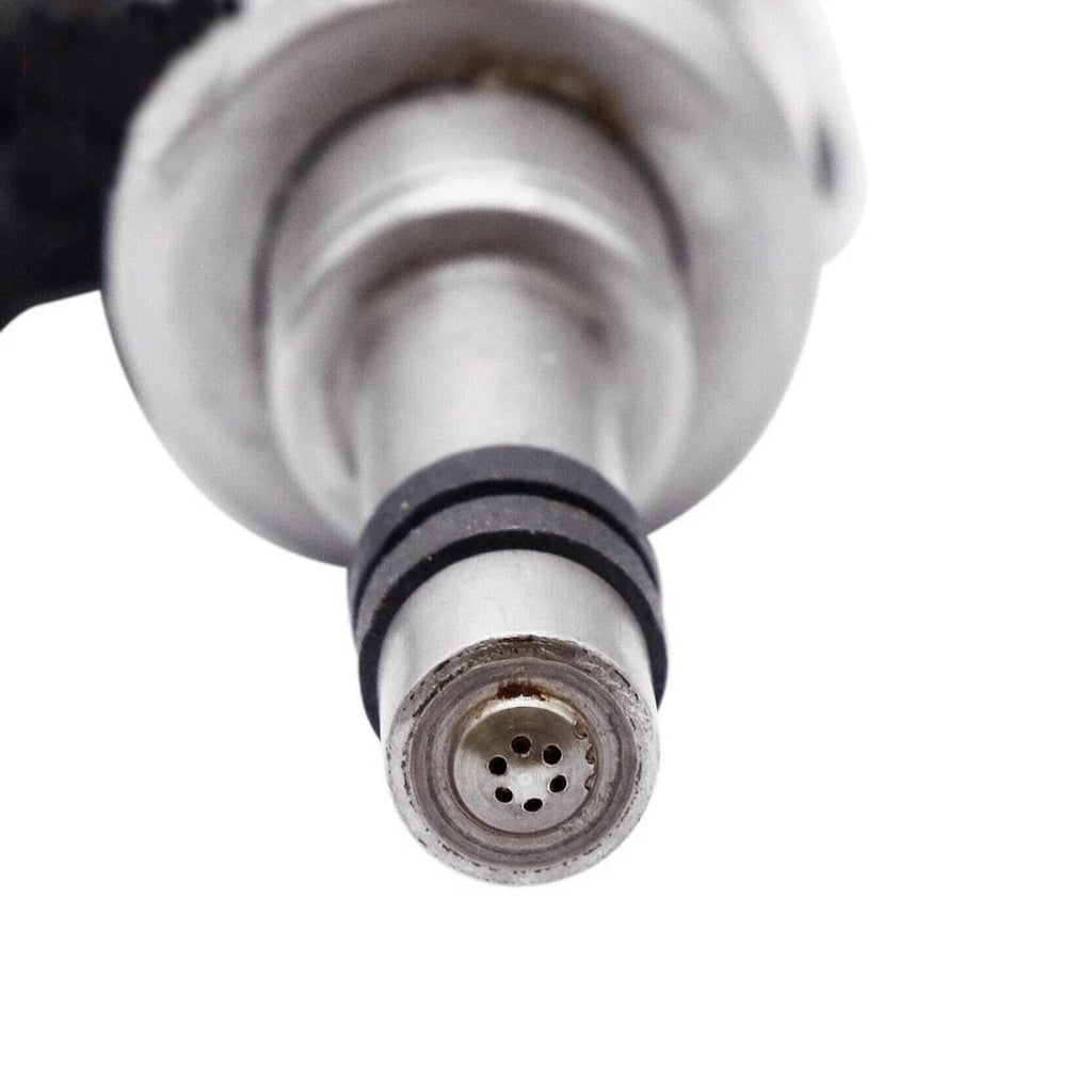 Fuel injector tip with circular connector and four small holes, close-up view