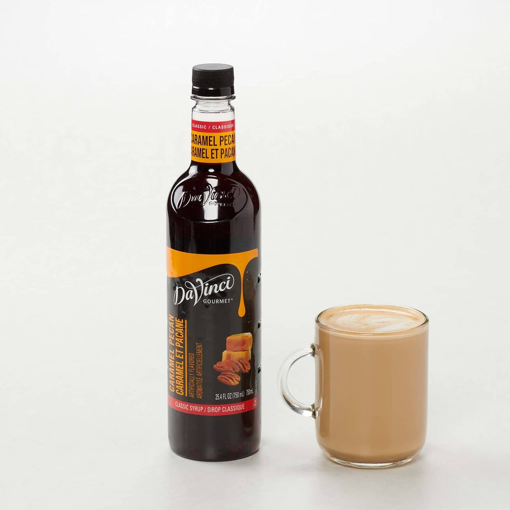 DaVinci Gourmet caramel pecan syrup bottle with glass mug of caramel-colored drink
