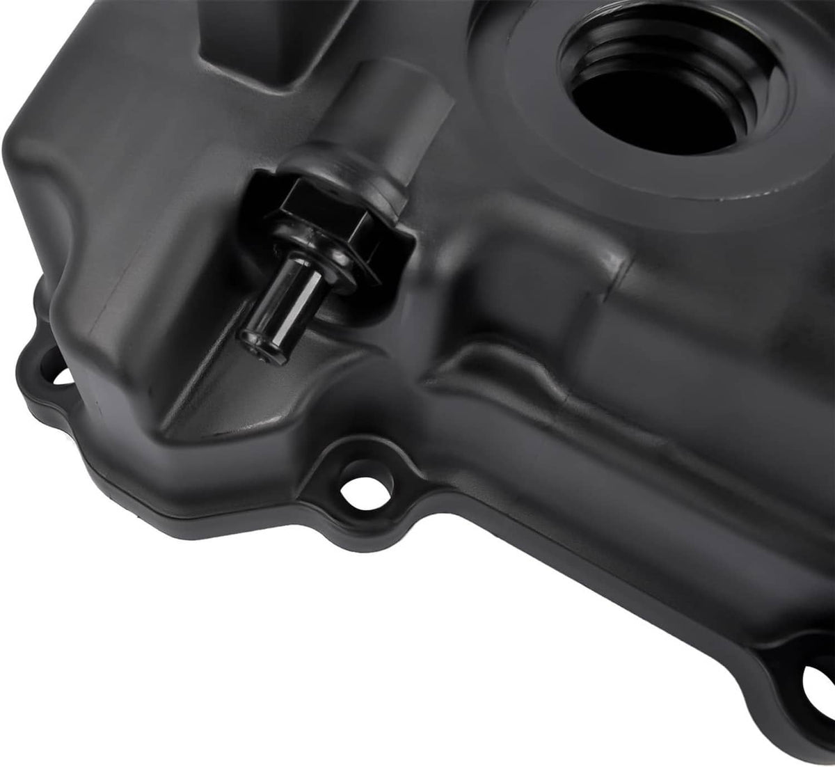 Close-up of black engine valve cover with connector port and surrounding molded shape