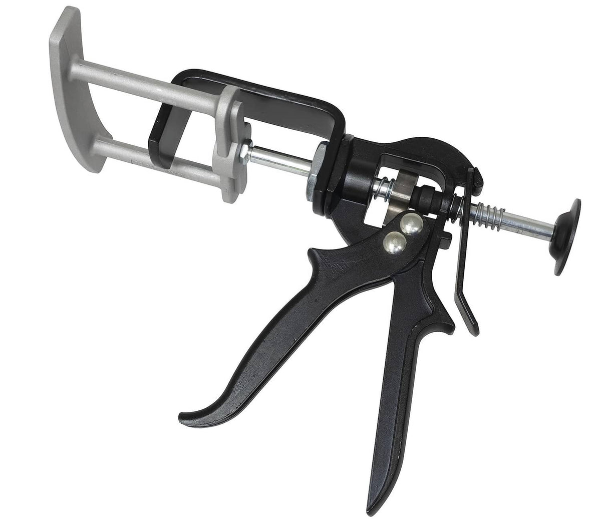 Dual piston brake pad spreader tool with black trigger handle and gray metal frame