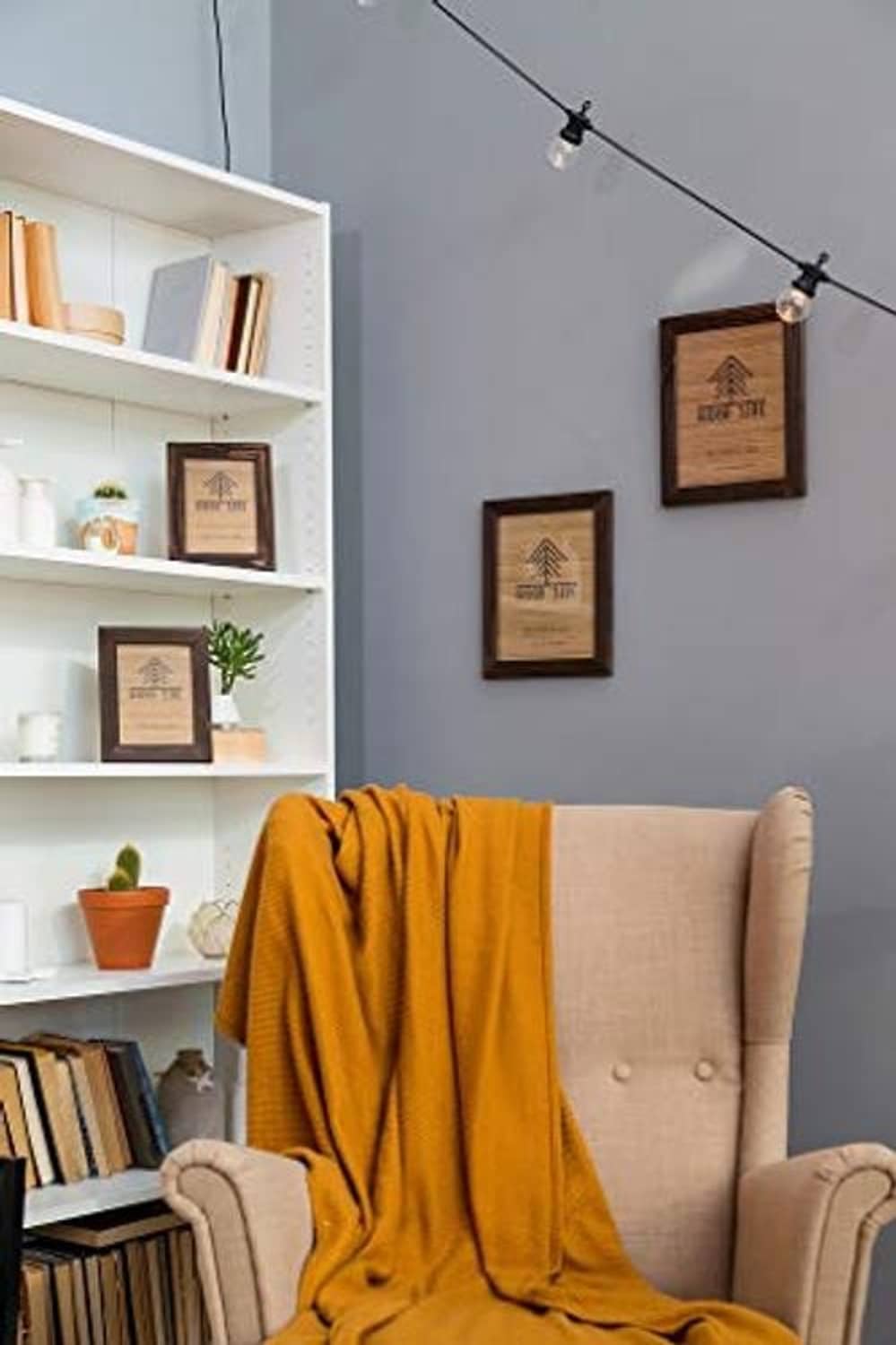 Wood poster frame on wall above sofa, dark brown rustic border