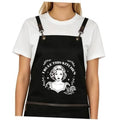 Black cross-back apron with chef-style graphic and adjustable leather buckles
