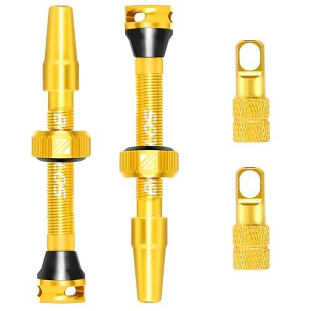 Gold Presta tubeless valve stem kit with two valve stems and two knurled caps.