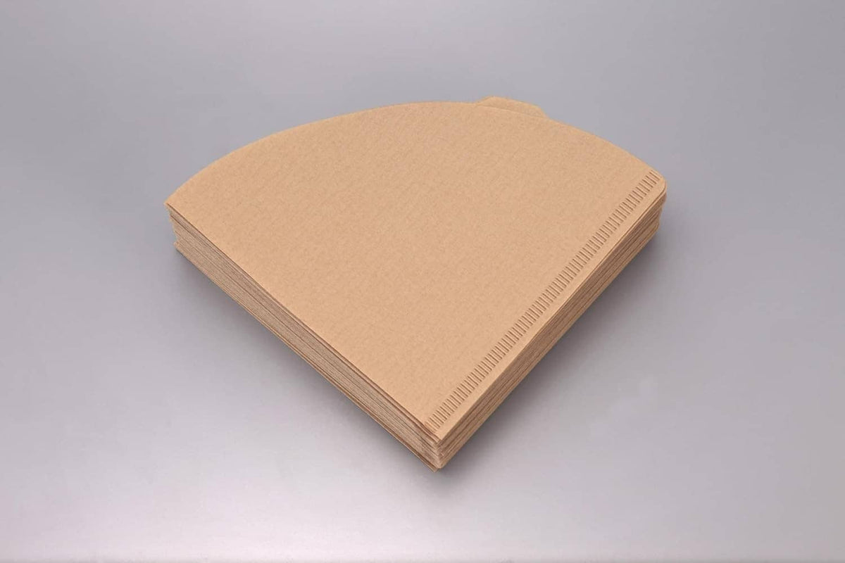 Stack of natural paper coffee filters, folded cone sheets