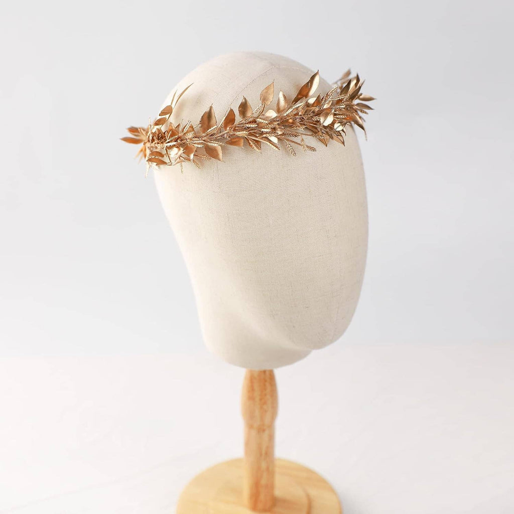 Gold leaf hair wreath on beige headform with brown adjustable ribbon ties