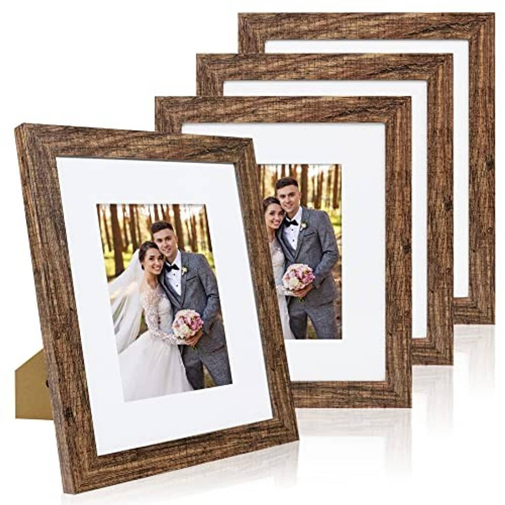 Stacked set of 4 rustic brown picture frames with white mats and portrait photos