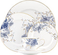 Porcelain place setting with blue floral cup and saucer, plus large dinner and accent plates