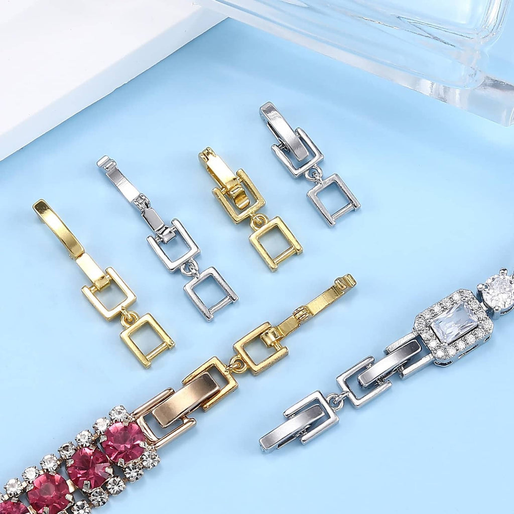 Assorted silver and gold fold-over clasp extender links on jewelry bracelet