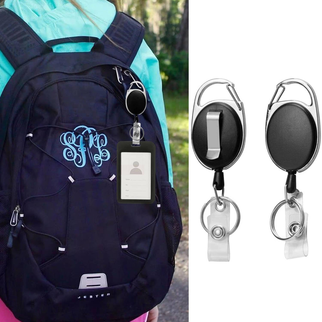 Black retractable badge holder clipped to a backpack, holding an ID card