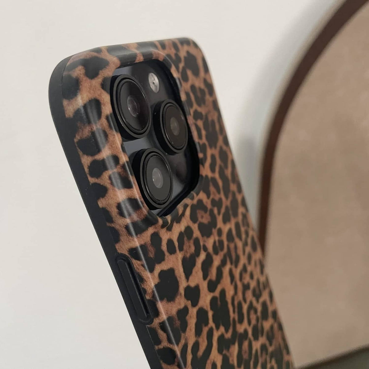 Brown leopard print phone case close-up of camera lenses and surrounding cutouts