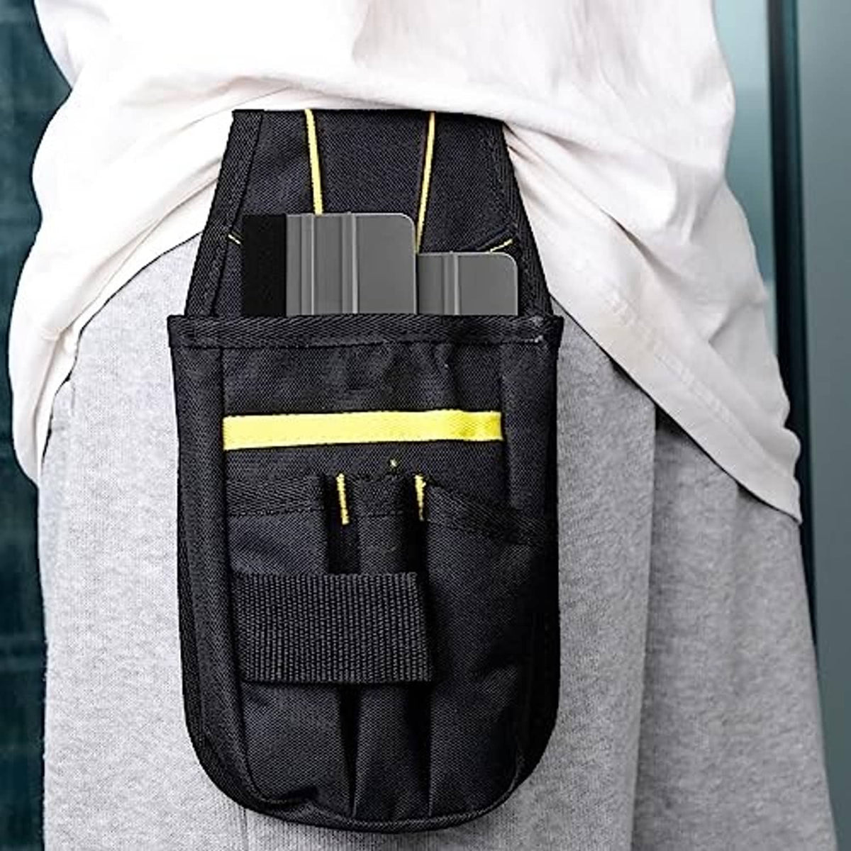 Black tool pouch holding multiple gray felt squeegees with black felt edges