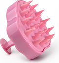 Pink scalp massager brush with soft silicone bristles for exfoliating scalp