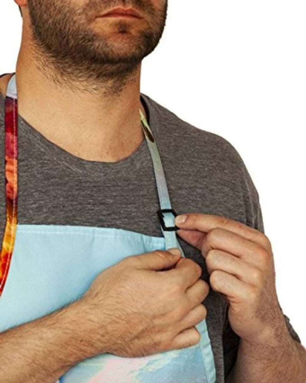 Adjustable neck strap buckle on unicorn print apron, red trim, close-up