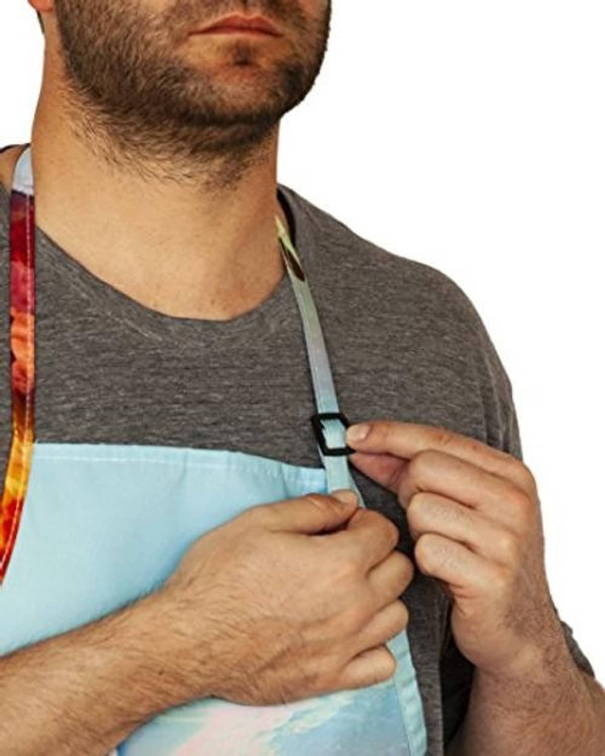 Adjustable neck strap buckle on unicorn print apron, red trim, close-up