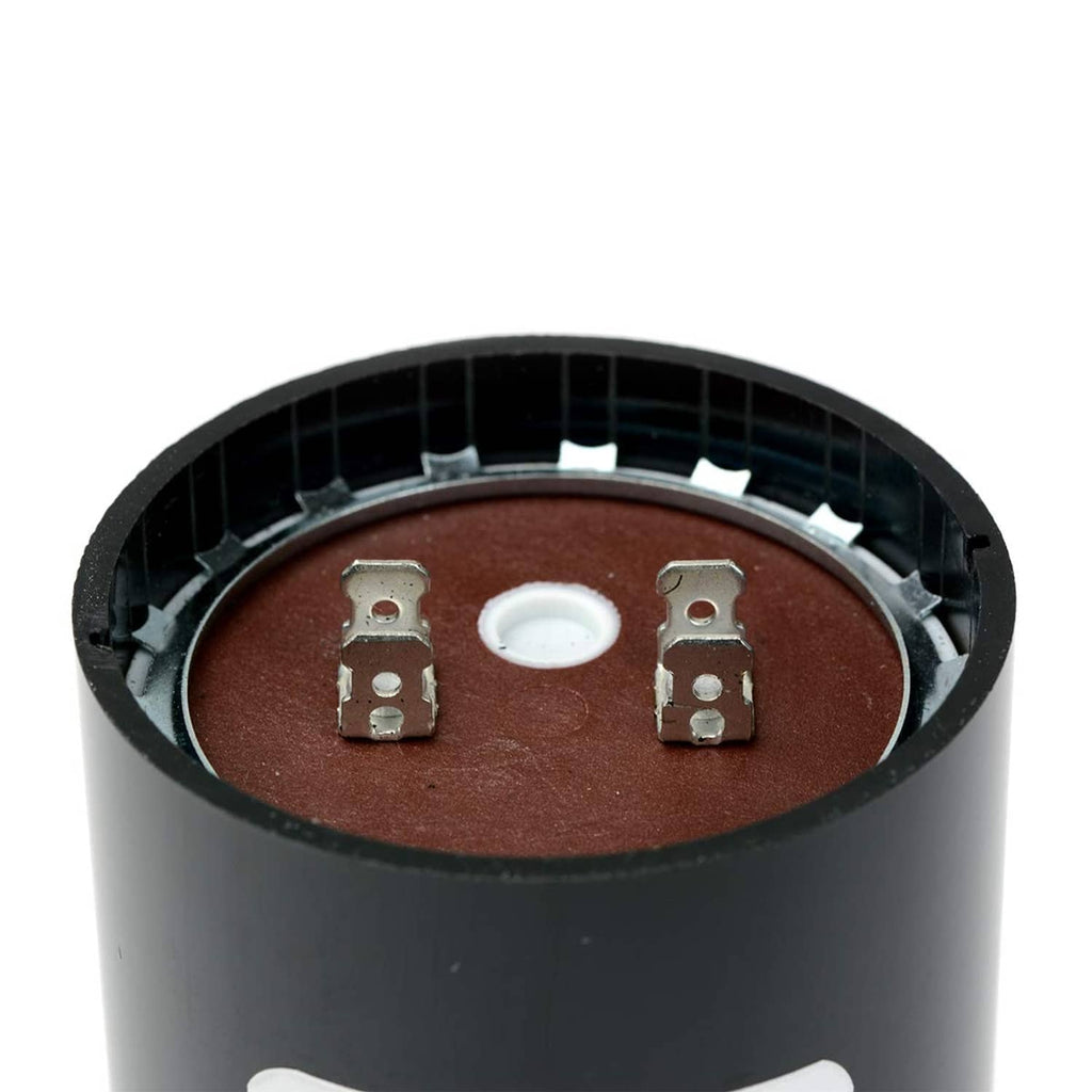 Close-up view of black cylindrical start capacitor terminals and center insulator