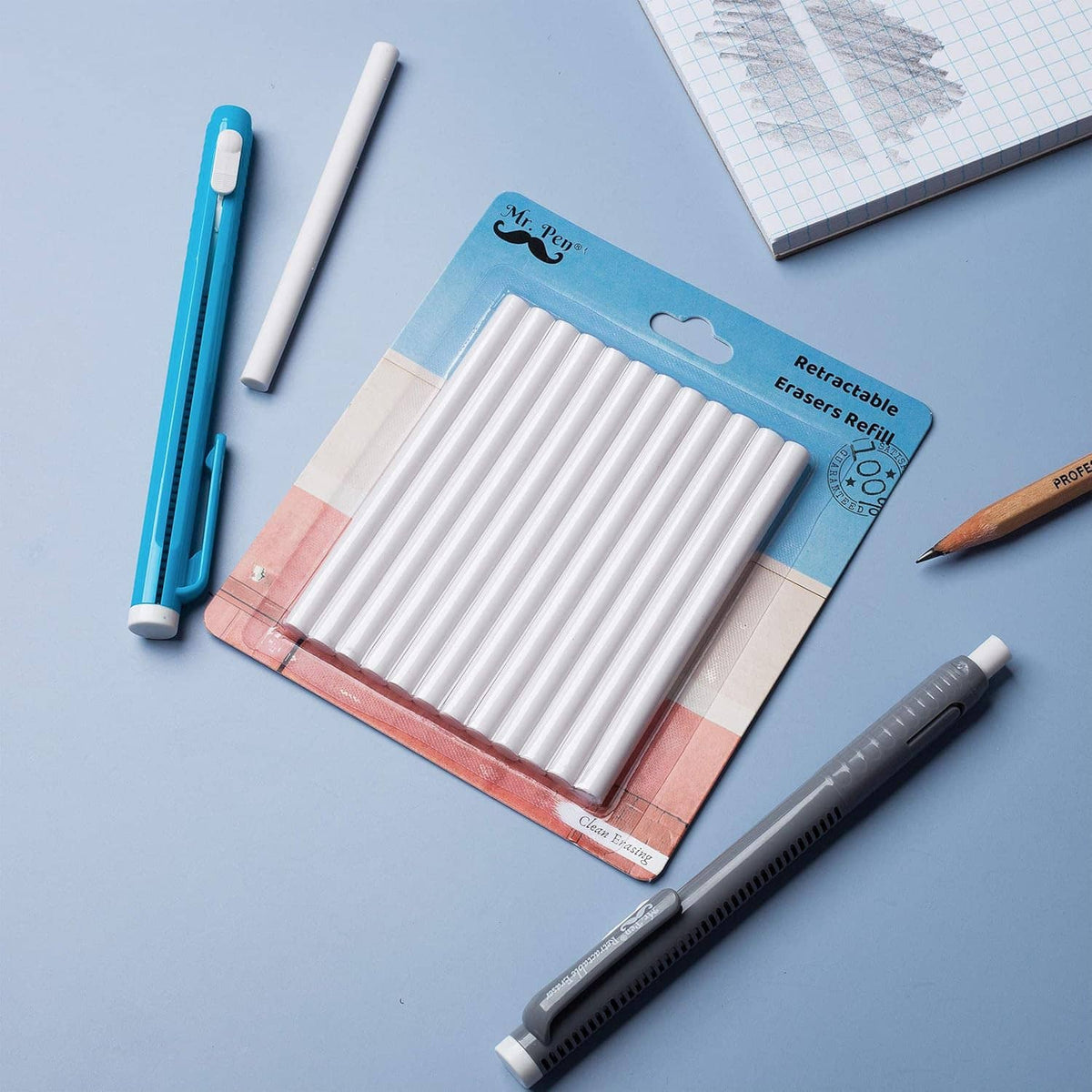Eraser refill sticks in retail packaging with retractable pen and pencil on desk